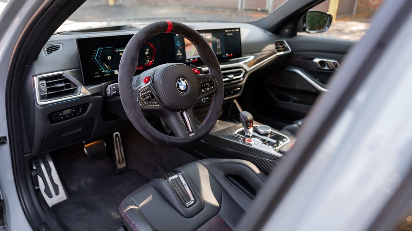 A photo of a car's interior facing its steering wheel.