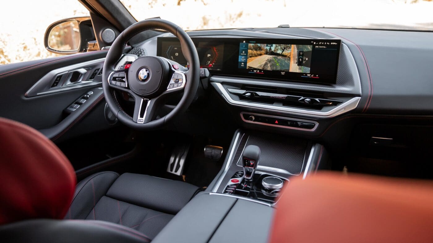 A photo of a steering wheel and dashboard.