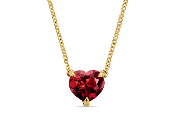 Explore our 2024 Valentine's Day Gift Guide to discover this elegant gold chain necklace, showcasing a heart-shaped red gemstone pendant secured with three prongs. Perfect for expressing your love.