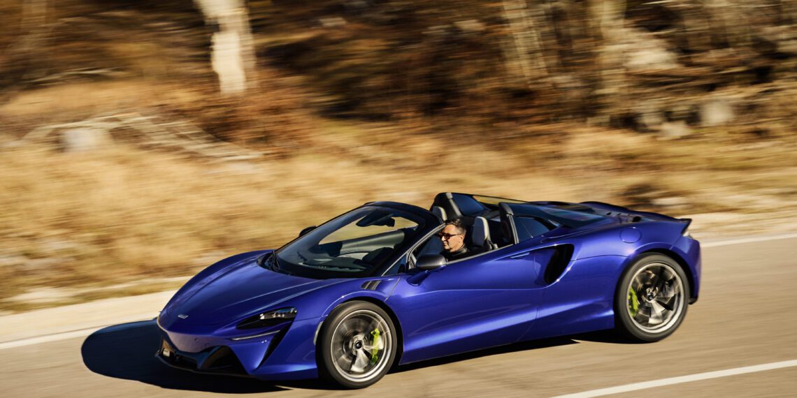 An image of a McLaren Artura Spider on the road.