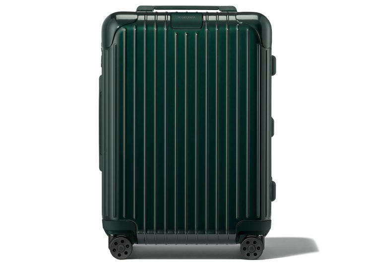 A green hard-shell suitcase with vertical grooves, four wheels, and a sturdy handle is featured in the duPont REGISTRY Gift Guide.