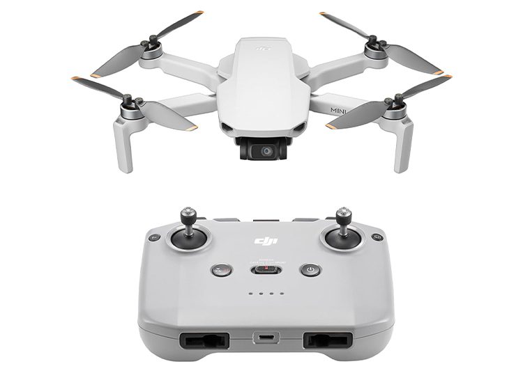 A compact white quadcopter drone with a camera and its remote controller, both on a white background, makes an exceptional addition to any gift guide. Perfect for tech enthusiasts or as a unique surprise for Valentine’s Day.