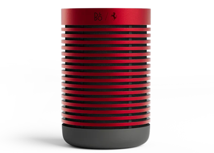 A cylindrical red and black speaker with horizontal slats, displaying a minimalist design that Ferrari enthusiasts will appreciate.