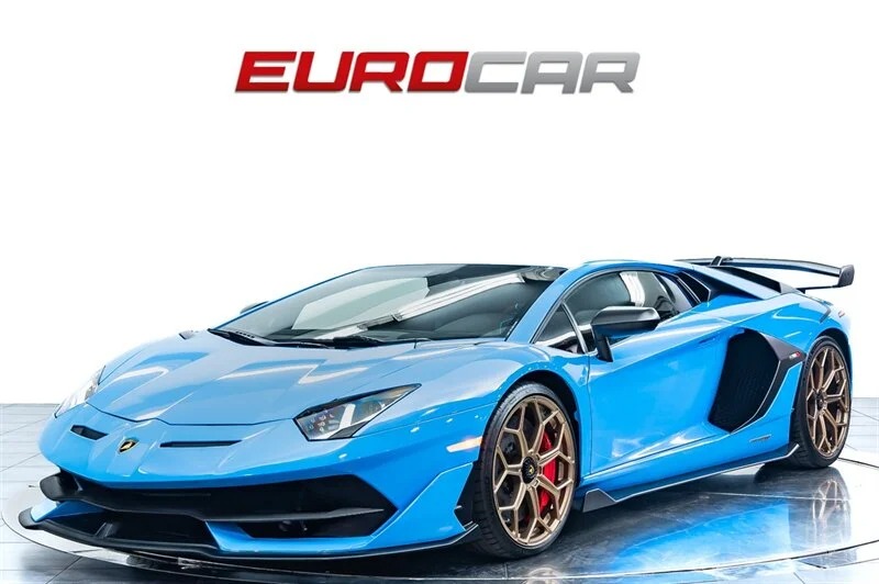 Displayed under the "EUROCAR" sign against a white background, this blue Lamborghini Aventador SVJ with striking bronze rims invites you to envision the thrill. Ready to buy today?