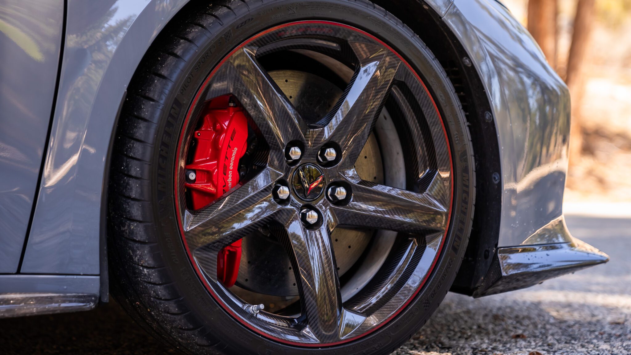 A close up shot of a car's carbon-fiber wheel.