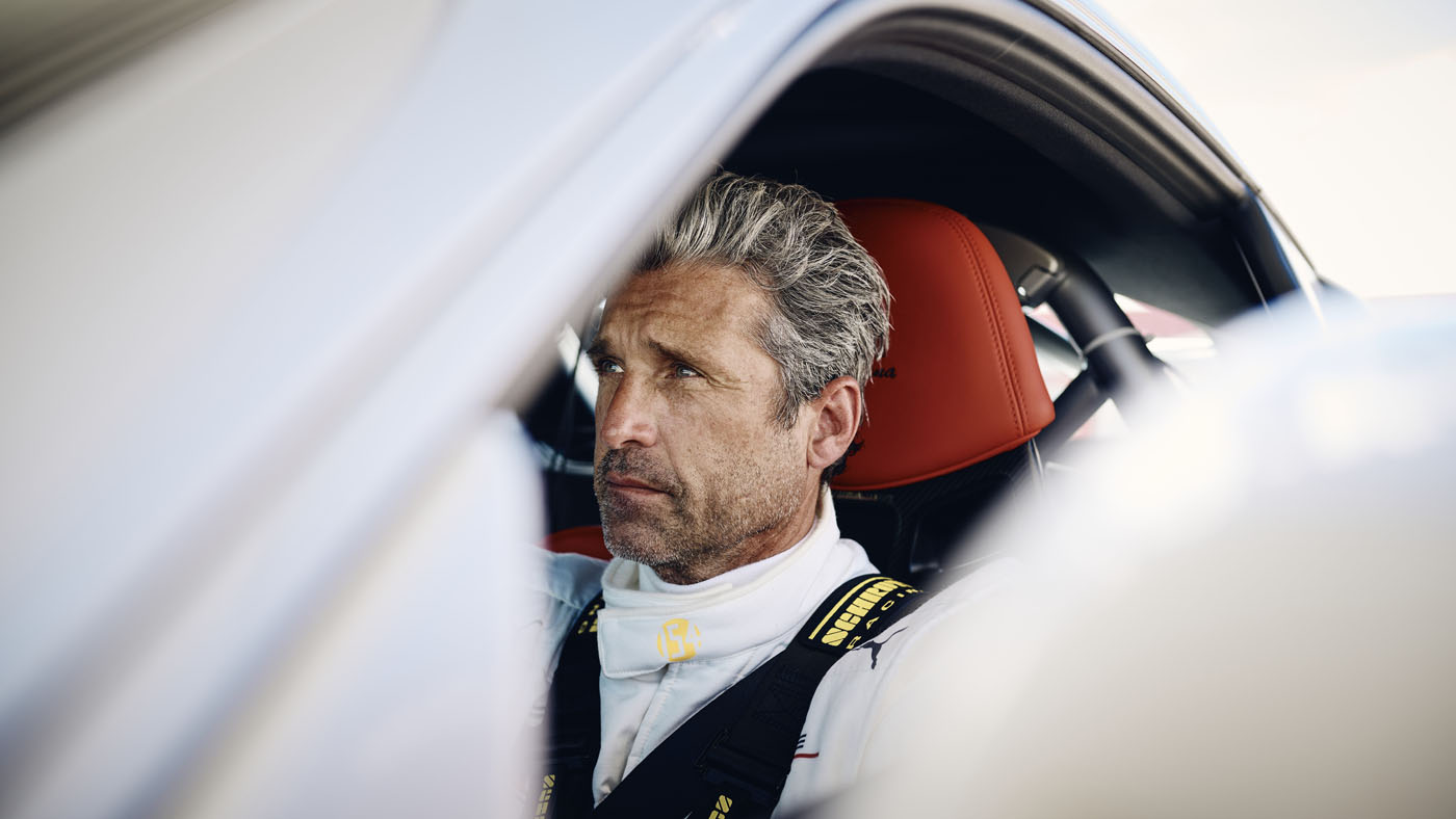 Patrick Dempsey behind the wheel of a Porsche