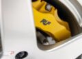 Close-up of a yellow RUF brake caliper behind a silver alloy wheel on the ultra-rare 2012 RUF Rt 12 R.