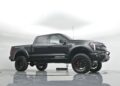 A black Hennessey VelociRaptor 600 pickup truck, blending luxury truck style with off-road capability, is parked in a white studio showcasing its lifted suspension and rugged tires.