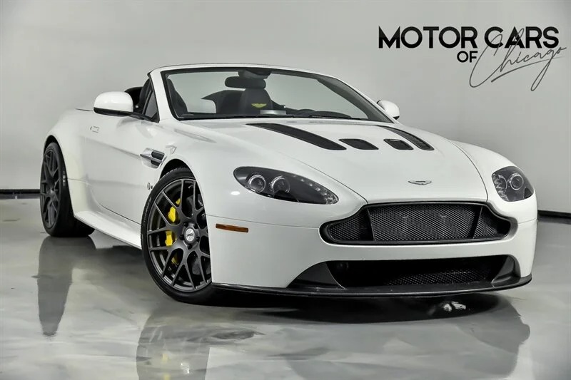 A white Aston Martin sports car with black stripes, this British luxury performance machine exudes style and power.