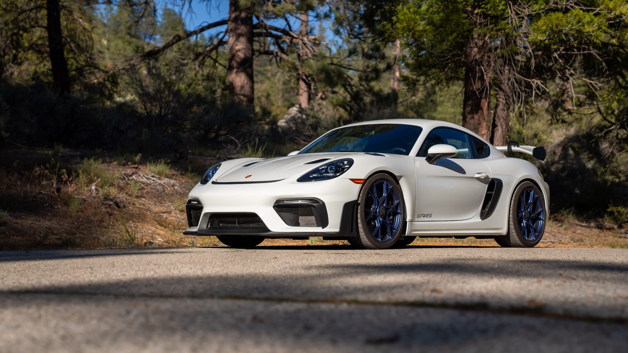 An image of a Porsche 718 Cayman GT4 RS parked outdoors.