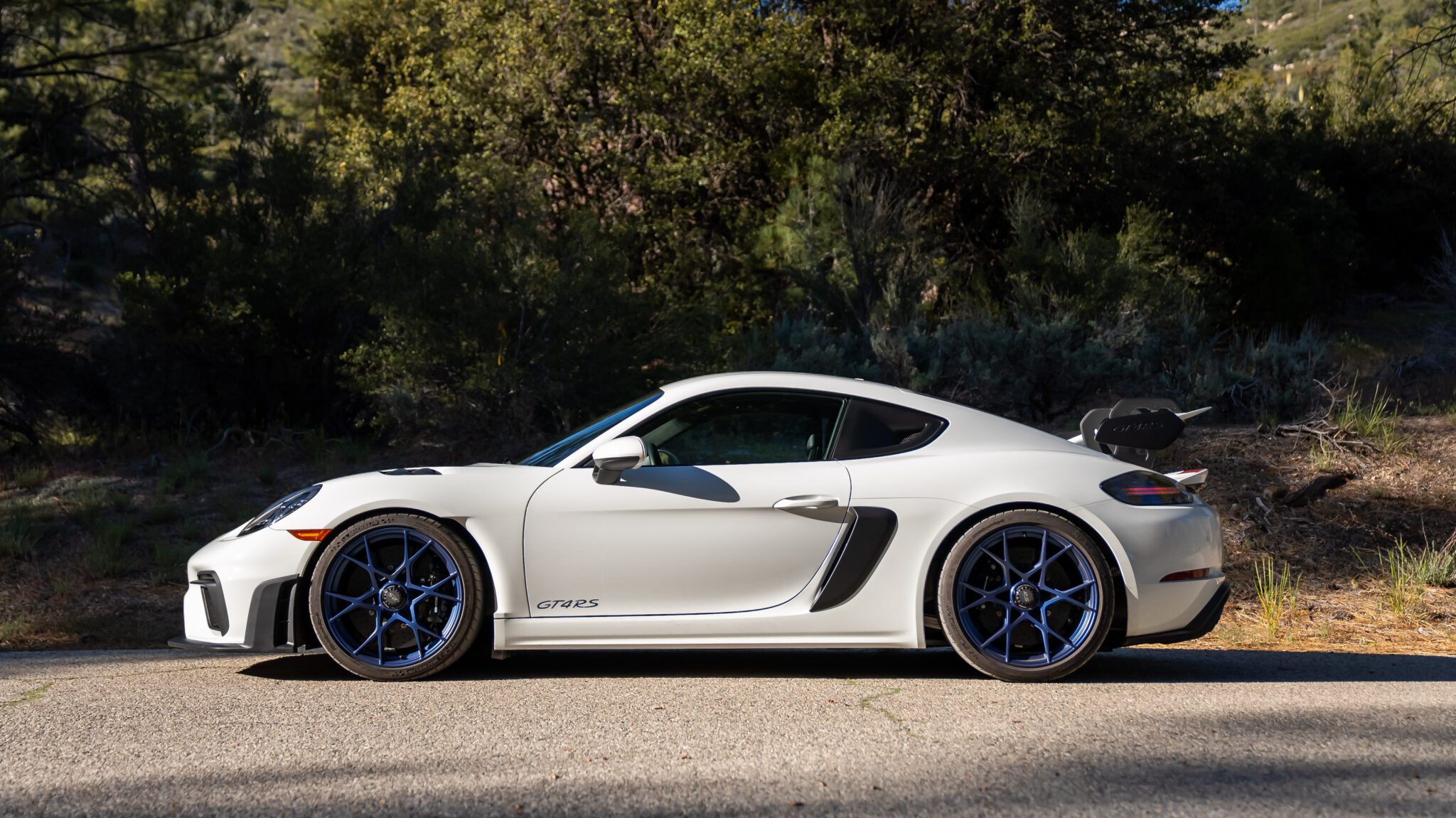 An image of a Porsche 718 Cayman GT4 RS parked outdoors.