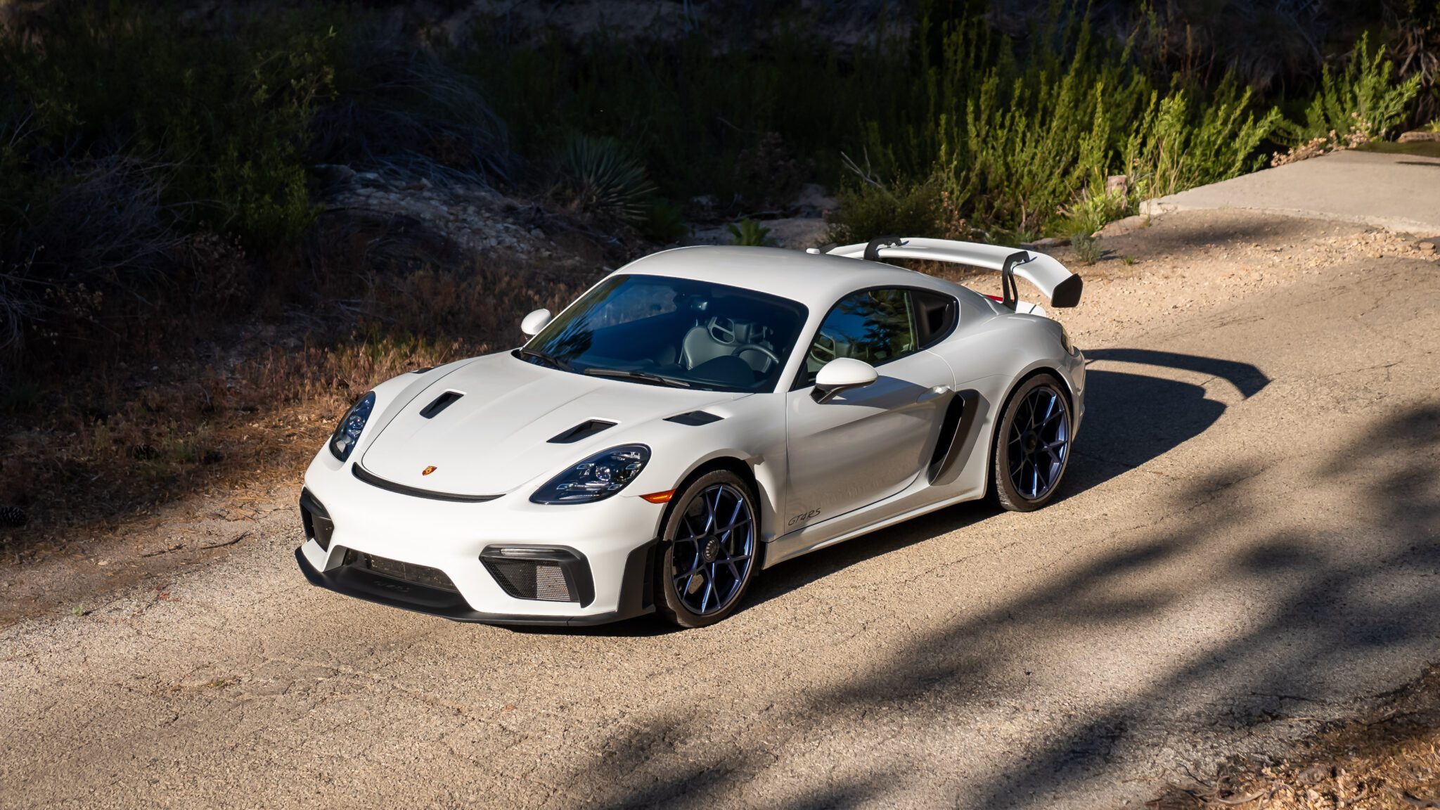 An image of a Porsche 718 Cayman GT4 RS parked outdoors.