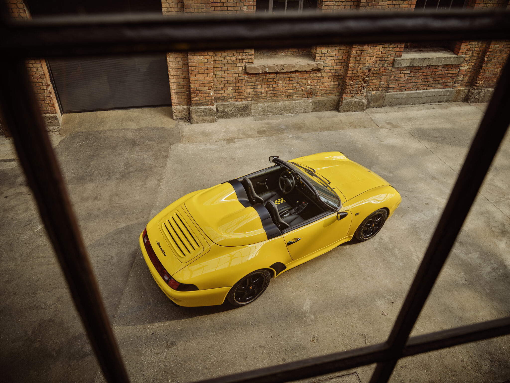 An image of a Porsche 911 Speedster in a warehouse.