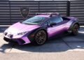 A metallic purple Lamborghini Huracán V10 supercar with roof racks and off-road modifications is parked in front of a sign that reads “Vegas Auto Gallery,” where this stunning vehicle is for sale.