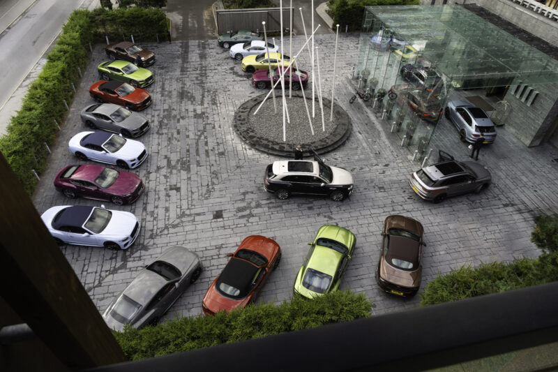 An image of car's lined-up in a parking lot.