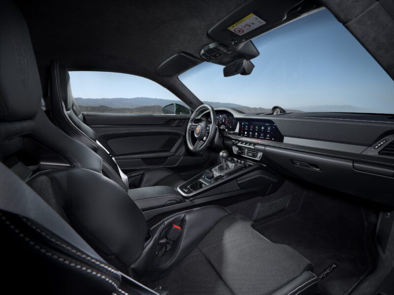 Step inside the 2025 Porsche 911 GT3, where black leather seats and a sleek dashboard await. With digital displays and a manual gear shift as part of the Touring Package, this modern sports car combines style with cutting-edge technology for a thrilling drive.