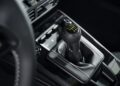 Close-up of a manual gear shift lever in a Porsche 911 GT3 interior, with visible stitching on the surrounding leather boot, part of its striking Touring Package design.