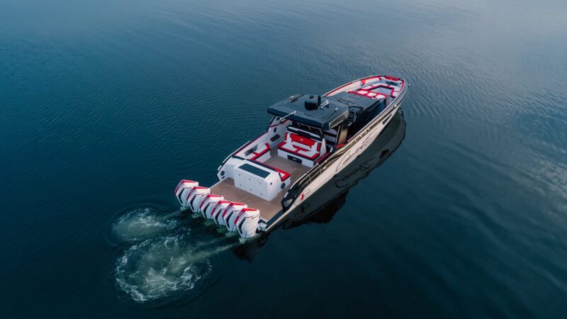 At the 2024 Fort Lauderdale International Boat Show, a motorboat with five outboard engines speeds across calm water, reflecting the opulence of luxury yachts.