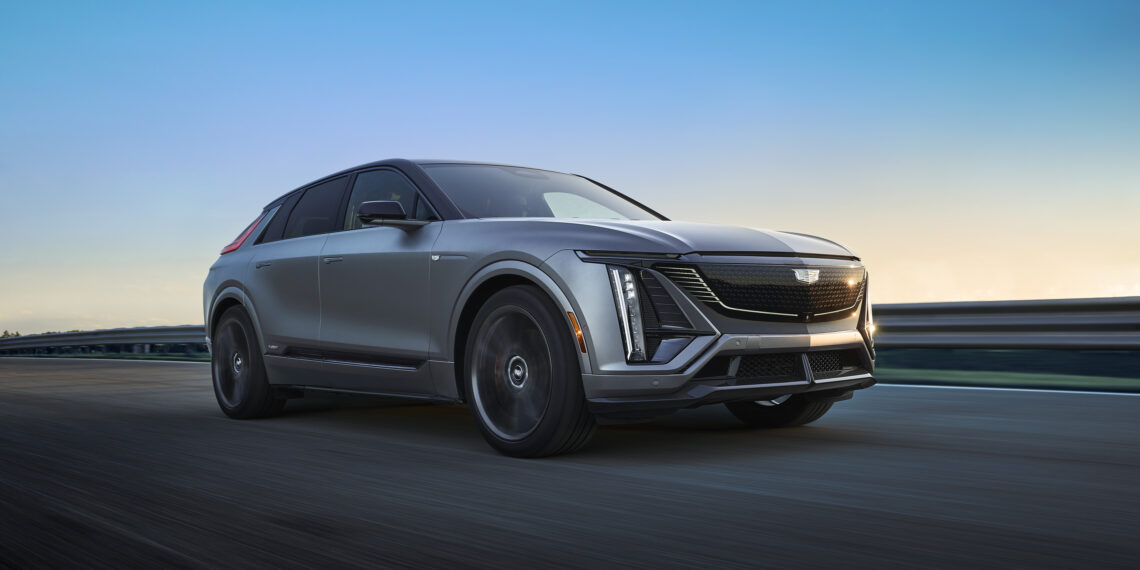 As the sun dips below the horizon, a sleek 2026 LYRIQ-V glides effortlessly along the road, embodying Cadillac's cutting-edge Electric V-Series Model beneath the clear evening skies.