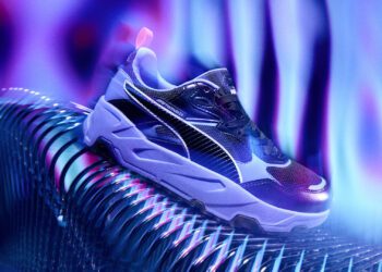A purple high-top sneaker with black accents sits on a reflective surface, embodying the Neon Energy Collection vibe, surrounded by a vibrant, wavy blue and purple background reminiscent of the Las Vegas GP-Inspired spirit.