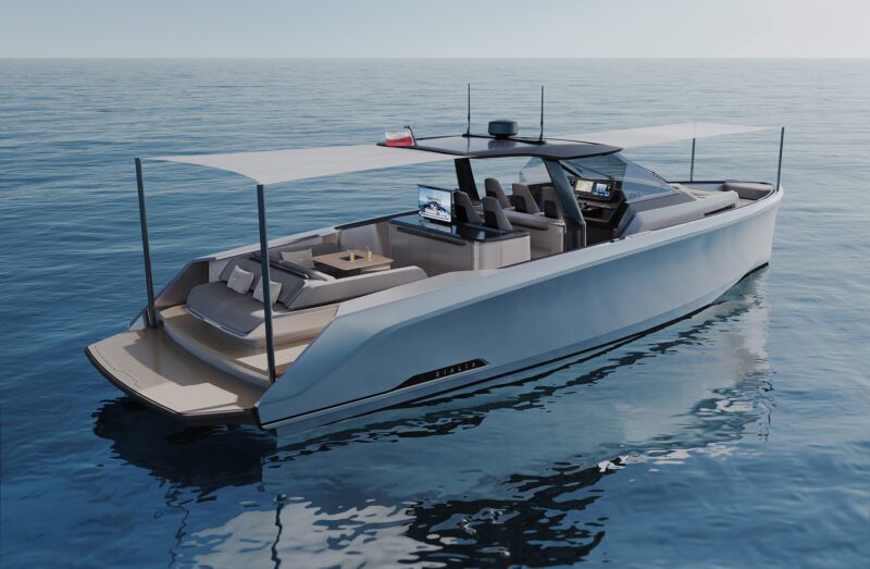 A modern luxury yacht with a sleek design glides on calm water. It features a shaded deck, multiple seating areas, and a control console, epitomizing 2024's finest craftsmanship showcased at the Fort Lauderdale International Boat Show.