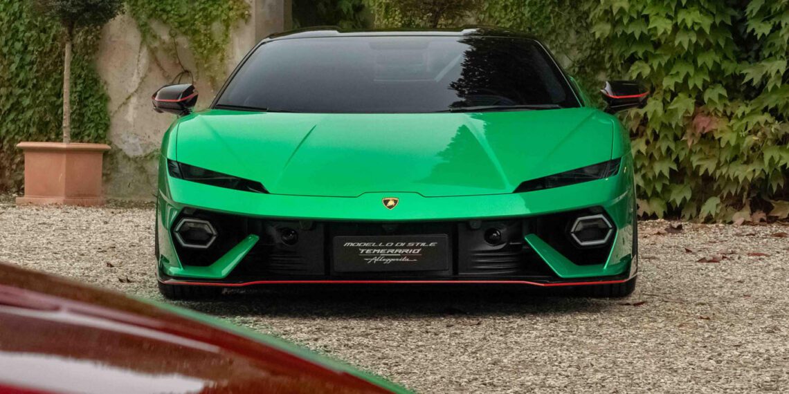 A sleek Lamborghini sports car is parked on a gravel path, surrounded by leafy greenery, embodying the sophisticated design celebrated in the 2024 Autostyle Design Competition in Italy.