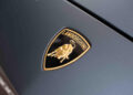 Close-up of the Lamborghini logo on the hood, showcasing a golden bull on a black shield with "Lamborghini" above it. This iconic emblem embodies the spirit of Italian craftsmanship, as admired in events like the 2024 Autostyle Design Competition in Italy.