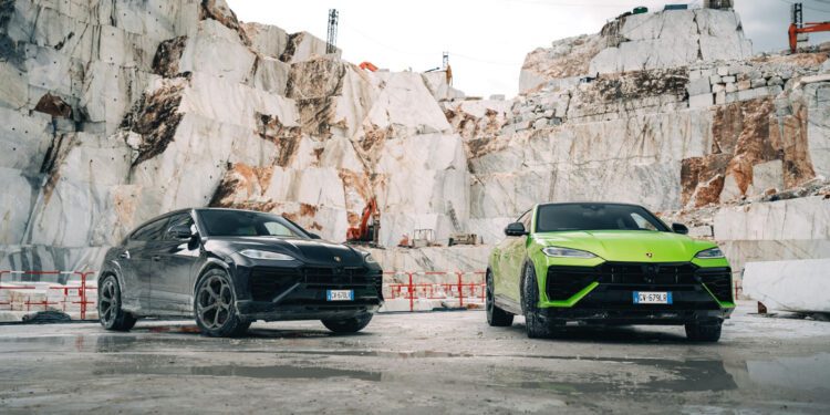 A black and a green Lamborghini SUV, including the Urus SE, stand majestically in a marble quarry with stone walls and a cloudy sky above, ready for the ultimate test drive event.