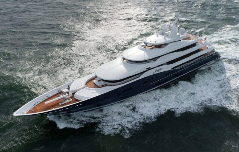 A large luxury yacht glides majestically through the ocean near Fort Lauderdale, creating a wake in the water as if previewing its presence at the International Boat Show.