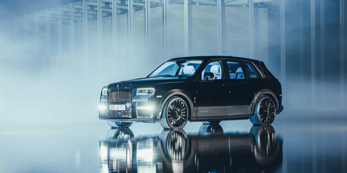 A black Rolls-Royce Cullinan is elegantly parked on a reflective surface in front of a modern architectural structure, enveloped by mist and dramatic lighting.