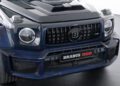 Close-up of the front of a blue Brabus 800, a Custom Mercedes AMG G 63, showcasing its grille and headlights, with a logo and "Brabus 800" label prominently visible.