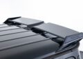 Close-up of a black car roof with a custom Mercedes-AMG Brabus spoiler, featuring two aerodynamic fins against a plain white background.