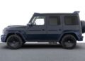 A dark blue, boxy Custom Mercedes-AMG SUV with tinted windows and large black wheels is parked on a gray surface, showcasing the sleek G 63 Configurations, viewed from the side.