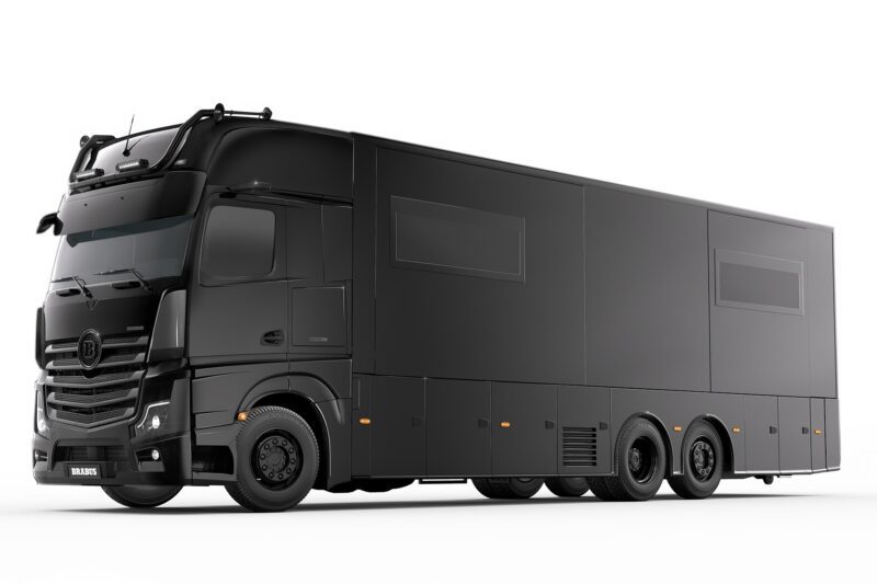 A sleek black BRABUS semi-truck with covered windows and modern design elements, viewed from the side, evokes the luxurious feel of a BIG BOY 1200 Motorhome.