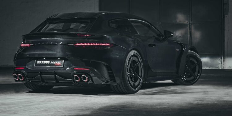 A black Brabus Rocket 900 Hyper GT car is parked in a dimly lit garage, viewed from the rear side.