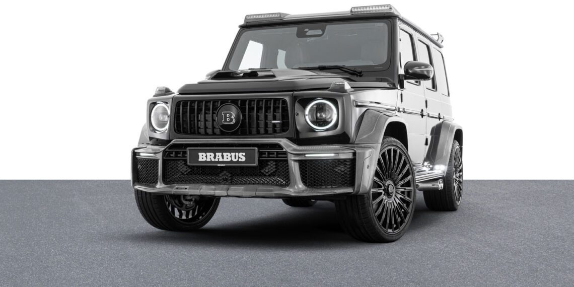 A sleek black BRABUS SUV, enhanced with Custom Mercedes-AMG elements, is displayed on a gray surface against a pristine white background.