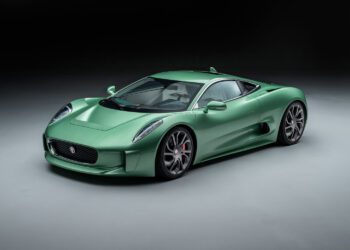 Green sports car with sleek design and two-door coupe body style, displayed on a gray background.