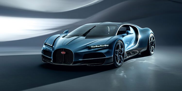 A sleek blue Bugatti sports car with a modern design is parked indoors, featuring next-century aerodynamic curves and black alloy wheels.