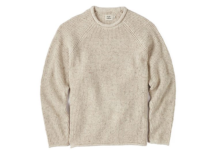 A beige, knitted sweater with a textured pattern and long sleeves is perfect for those cooler months. Displayed on a white background, this cozy piece is a must-have from our Fall Shopping Guide.