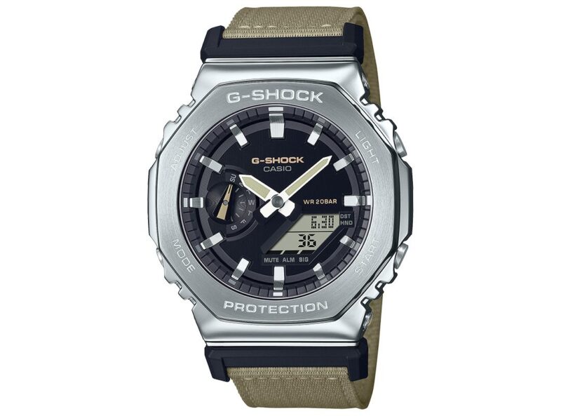 Close-up of a Casio G-SHOCK watch with a silver and black face, digital and analog displays, and a beige strap. A perfect choice for affordable watches to start your collection under $500.