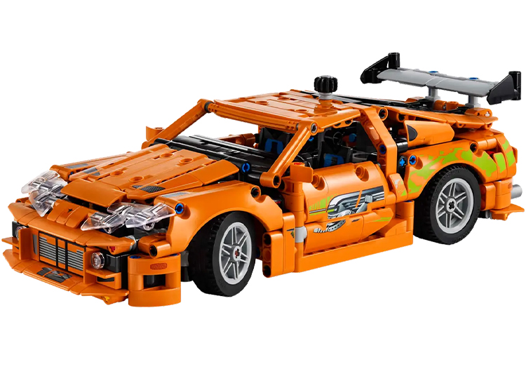 Orange toy sports car with green decals, detailed bodywork, and a large rear spoiler, reminiscent of the best automotive-inspired LEGO sets.