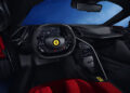 The interior of this hypercar boasts a high-tech dashboard with a digital display, a steering wheel adorned with buttons, and luxurious red upholstery, reminiscent of a Ferrari.