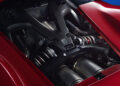 Close-up view of a Ferrari F80 Hypercar's engine compartment, showcasing metallic components and branding.