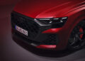 Close-up of a red Audi RS Q8 showcasing a prominent grille, distinctive headlights, and alloy wheels, embodying the essence of an Audi Sport Model with unparalleled performance.