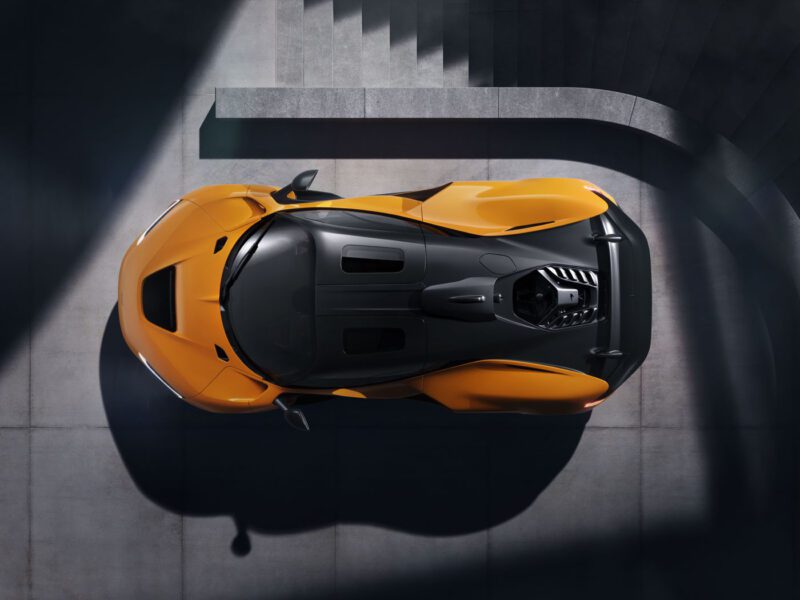 Top view of a McLaren W1 sports car with a sleek design, parked on a concrete surface with minimal shadows.