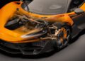 A high-tech McLaren W1 sports car features a transparent overlay, revealing its innovative 3D printed suspension and brake system details.