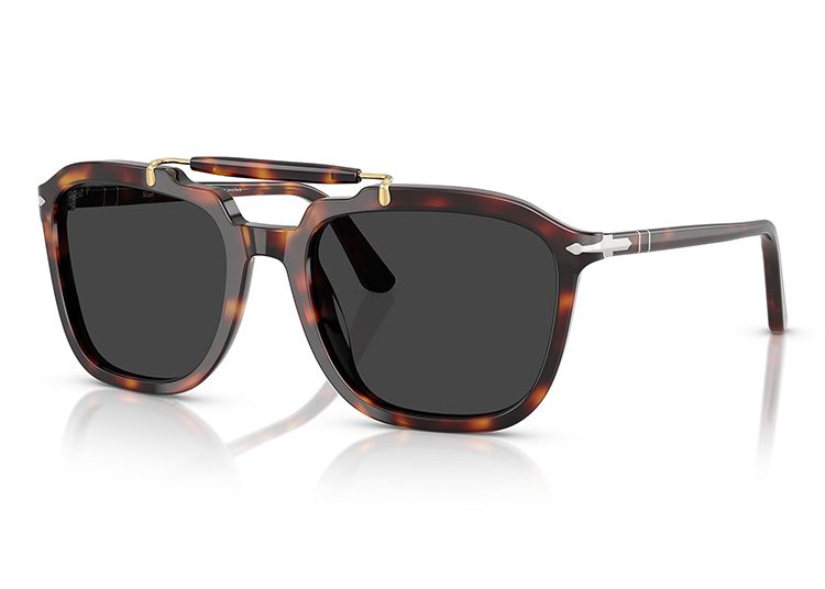 Tortoiseshell sunglasses featuring dark lenses and a gold bridge detail, expertly styled for the cooler months, rest elegantly on a reflective white surface.