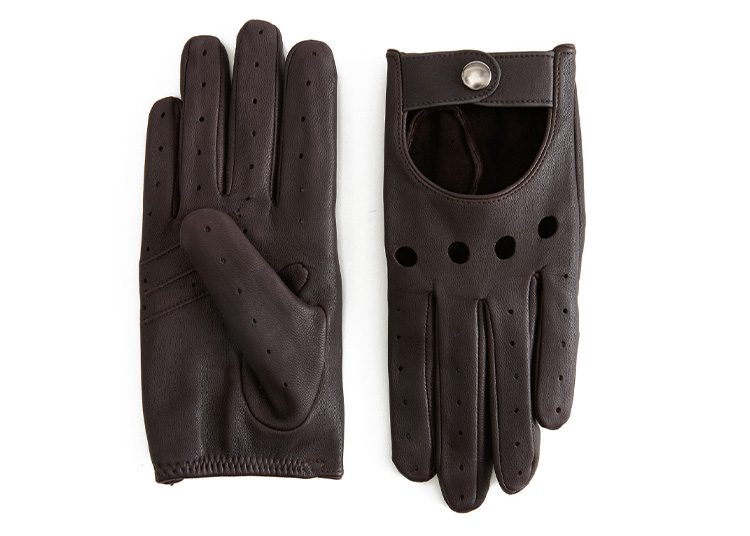 A pair of dark brown leather gloves, ideal for the cooler months, features one glove facing up to show its sleek fingers, while the other faces down, highlighting a round snap button and elegant perforations. Perfect addition for any stylish fall shopping guide.