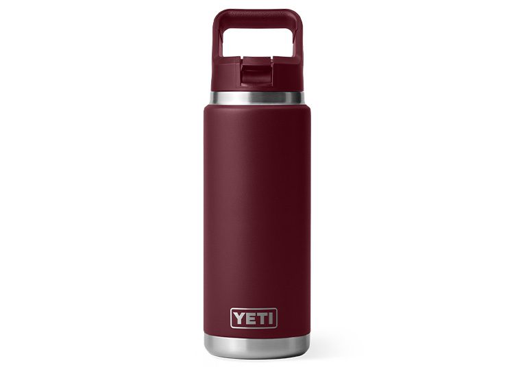 A maroon Yeti water bottle with a handle cap stands upright on a white background, ready to be your go-to accessory during the cooler months. Perfect for staying hydrated and stylish, this bottle makes an excellent addition to your fall shopping guide wishlist.