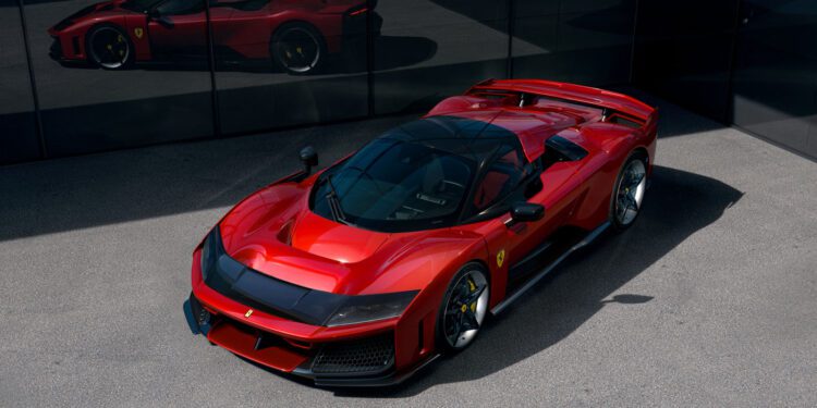 A gleaming Ferrari F80 sports car is parked on the gray pavement, its bold design and impressive specs mirroring in the glass building nearby.